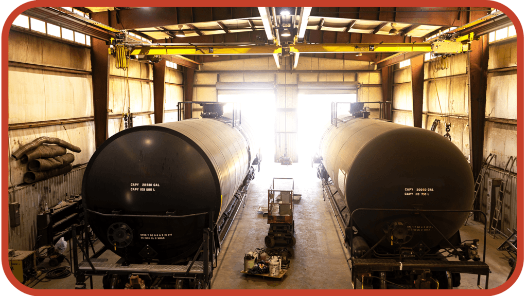 Interior view of a tank qualification facility showing two large storage tanks, labeled with capacity details, and industrial equipment in a well-lit environment. Ideal for discussing tank qualification strategies.